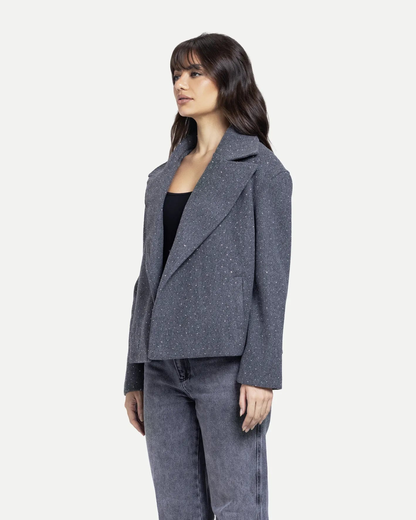 Woman wearing a gray suit on a white background